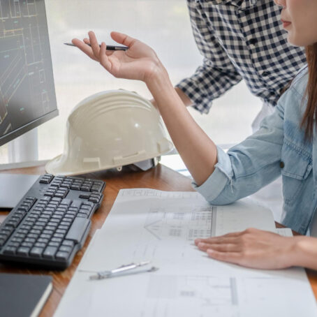 engineers-discuss-blueprint-while-checking-information-tablet-computer-office